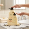 Dłoń naciska pompkę mydła w piance Vione Vanilla Blossom 2000 ml przy umywalc
